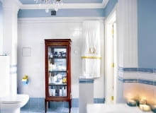 Meble łazienkowe są stylizowane na klasycystyczne z początku XIX wieku. Do tego stylu nawiązuje również żyrandol. Nawet wzory na ręczniku do złudzenia przypominają te sprzed dwustu lat.