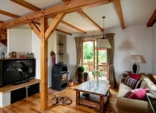 Pan Paweł zawsze marzył o domku w stylu country. Gdy tylko nadarzyła się okazja, by z mieszkania na warszawskim Ursynowie przenieść się do domu, z pewnym trudem przekonał do tego żonę. Dziś żadne z nich nie żałuje tej decyzji. Tym bardziej, że wiejska siedziba znajduje się niedaleko centrum miasta! <BR /> DOM. W nowym domu gospodarzy ujęły zwłaszcza sosnowe belki i podłoga z desek, również sosnowych - elementy charakterystyczne dla domów w wiejskim stylu. Meble, oprócz kilku odkupionych od poprzednich właścicieli, pochodzą z popularnych sklepów, a także z firmy projektantki, która pomagała w aranżowaniu wnętrz. salon, wystrój wnętrz, drewno we wnętrzu