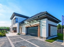 Widok od wejścia na posesję - najpierw garaż ze znajdującą się nad nim salą rekreacyjną, potem strefa wejścia nadbudowana o fragment centralny z dwiema sypialniami dziecięcymi Widok od wejścia na posesję - najpierw garaż ze znajdującą się nad nim salą rekreacyjną, potem strefa wejścia nadbudowana o fragment centralny z dwiema sypialniami dziecięcymi