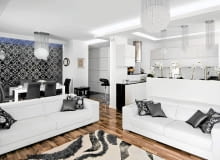 Olśniewająca biel ścian i mebli oraz mnóstwo światła - głównie sztucznego, rzucanego przez liczne lampy. W tej powodzi bieli wyróżniają się tylko czarne i srebrne dodatki. <BR /> MIESZKANIE. Graficzny, biało-czarny wystrój uzupełniają elementy połyskujące srebrem. Z meblami o prostych, nowoczes-nych formach zestawiono ozdobne kryształowe lampy i kinkiety, połyskujące czarno-srebrne poduszki i rolety. Lampy oraz tkaniny gospodarze sprowadzili z Turcji, skąd oboje pochodzą.