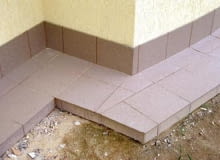 Opaska betonowa obłożona płytkami ceramicznymi. Cóż z tego, że nawierzchnia jest wykonana bardzo starannie, skoro będzie pękać? OPASKA BETONOWA OBLOZONA PLYTKAMI CERAMICZNYMI WOKOL DOMU FOT. CEZARY SZEJGIS PUBLIKACJA LADNY DOM NR 5 (67) - 5.2004