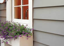 Siding na elewacji Fiber-cement siding is manufactured to resemble cedar shingles and wood clapboards (either wood-grain or smooth).