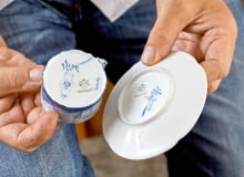 ...kiedy część wyprodukowanej porcelany wysyłano do Delft, miasta znanego z kunsztu holenderskich malarzy zdobiących słynny fajans. Na denku są więc sygnatury obydwu manufaktur. ...kiedy część wyprodukowanej porcelany wysyłano do Delft, miasta znanego z kunsztu holenderskich malarzy zdobiących słynny fajans. Na denku są więc sygnatury obydwu manufaktur.