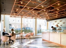 Oświetlenie to ciekawa instalacja z metalowych rurek pomalowanych farbą w miedzianym kolorze, która wieczorami kameralnie oświetla wnętrze. cukiernia Odette, słodycze