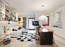 Długi stół posłużył do rozdzielenia salonu i aneksu kuchennego. Jednolite fronty kuchennych szafek nie rzucają się zbytnio w oczy. Dzięki temu salonu i aneks zachowują spójność stylistyczną. wystrój wnętrz, aranżacje wnętrz