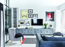 WŚRÓD WIELU OBRAZÓW, które od lat zbiera właścicielka (na ścianie m.in. prace Jerzego Nowosielskiego, Franciszka Starowieyskiego i fotografie Barta Pogody), jest też dzieło projektantki: oprawiony w ramy wąski skrawek tapety z motywem gazet (po lewej). - W moim mieszkaniu wszędzie piętrzą się sterty czasopism. Mam do tej tapety stosunek emocjonalny - śmieje się Paulina. Metalowe szafki pod telewizorem są z BM Housing, fotel z CustomForm, stolik kawowy przyjechał z Berlina.