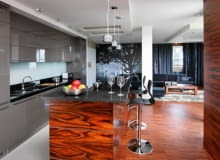 Widok katedry w Sewilli przesłoniętej rozłożystym drzewem uprzyjemnia gospodarzom wypoczynek przez cały rok. Kolorystyka fototapety idealnie pasuje do odcieni zasłon i mebli, jednocześnie dodaje wnętrzu przestrzeni. <BR /> MIESZKANIE. Wystrój części dziennej jest bardzo spójny. Barwa kuchennych frontów z lakierowanej na wysoki połysk płyty MDF nawiązuje do odcienia tkanin w salonie. Obudowę wyspy i fronty wysokiej zabudowy (widocznej po prawej stronie) zrobiono z palisandru. Na podłodze - gres i parkiet przemysłowy z palisandru. Główny blat roboczy oświetlają halogeny zamontowane w częściowo podwieszonym suficie, wyspę - efektowne lampki wiszące, kąt wypoczynkowy - LED-y zamontowane w wycięciach sufitu. Widok katedry w Sewilli przesłoniętej rozłożystym drzewem uprzyjemnia gospodarzom wypoczynek przez cały rok. Kolorystyka fototapety idealnie pasuje do odcieni zasłon i mebli, jednocześnie dodaje wnętrzu przestrzeni. <BR /> MIESZKANIE. Wystrój części dziennej jest bardzo spójny. Barwa kuchennych frontów z lakierowanej na wysoki połysk płyty MDF nawiązuje do odcienia tkanin w salonie. Obudowę wyspy i fronty wysokiej zabudowy (widocznej po prawej stronie) zrobiono z palisandru. Na podłodze - gres i parkiet przemysłowy z palisandru. Główny blat roboczy oświetlają halogeny zamontowane w częściowo podwieszonym suficie, wyspę - efektowne lampki wiszące, kąt wypoczynkowy - LED-y zamontowane w wycięciach sufitu.