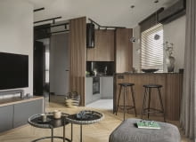 Kuchnia w kolorach i materiałach powtarzających się w aranżacji salonu tworzy spójną z przestrzenią dzienną, wspólną stylistycznie strefę.