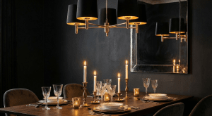 Nad stołem zawisła klasyczna lampa Ponte w eleganckim czarnym kolorze z zewnątrz i złotym w środku. Jej ciepłe światło wzmocnione zostało blaskiem świec.