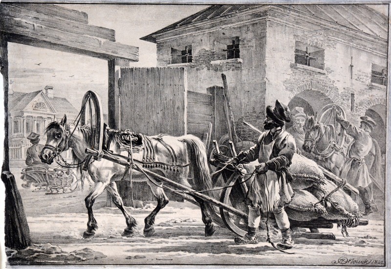 Візник, що йде попереду возу з мішками