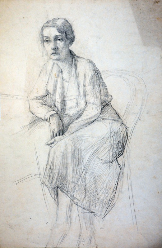 Жінка, що сидить біля столу