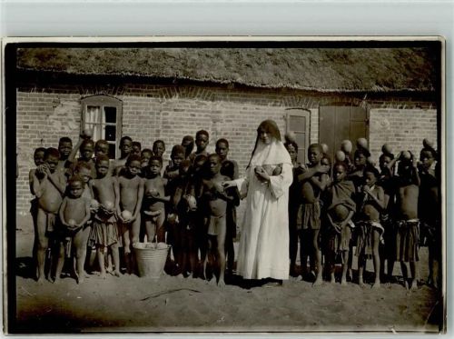 Mission Nonne verteilt an die Kinder Kokosnüsse