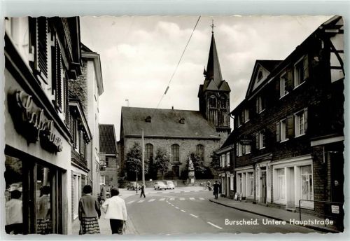 51399 W5093 Burscheid , Rheinl Foto AK Untere Hauptstraße mit Ev. Kirche