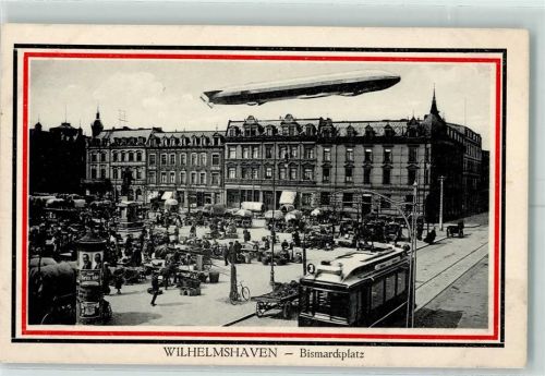 Wilhelmshaven Luftschiff über der Stadt Straßenbahn Marktszene Litfaßsäule AK