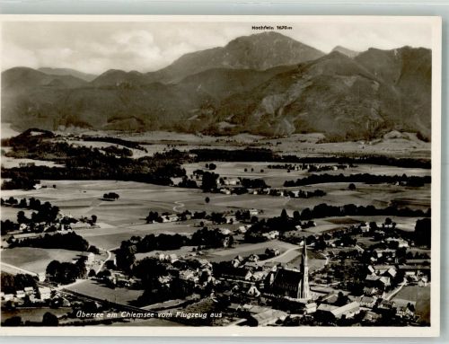 83236 W8212 Übersee Foto AK Fliegeraufnahme des Ortes mit Kirche St. Nikolaus und Hochfelln