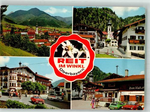 83242 W8216 Reit im Winkl Foto AK Panorama des Ortes mit Pfarrkirche St. Pankratius Gasthaus Zum Kuhstall Omnibus Porsche Edelweiss