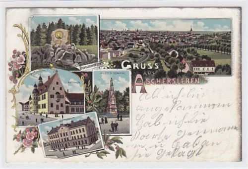 Aschersleben Lithographie Gruss aus Aschersleben. Bismarckstein Totalansicht Rathaus Krieger-Denkmal Gymnasium gelaufen 1900. Oxydationsspuren. Leichter Stempeldurchdruck, sonst gut erhalten.