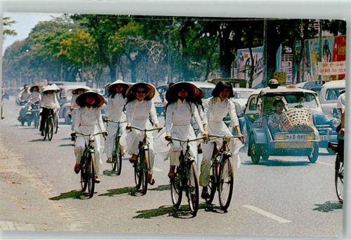 Hongkong - High School Girls cycling their way to class Traditional Dress called Ao Dai