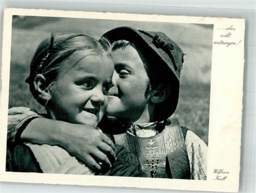 Kleiner Junge flüstert Mädchen in bayerischer Tracht ins Ohr Fotograf Wolfram Knoll Verlag Hermann A. Wiechmann Nr. 8510