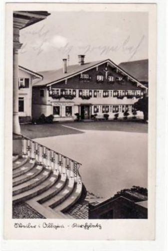 Fotokarte von Weiler im Allgäu. Kirchplatz Kaufhaus Martin Ferber gelaufen 1933 Eckbug oben links kleiner Riß an der unteren Kante, sonst gut erhalten.