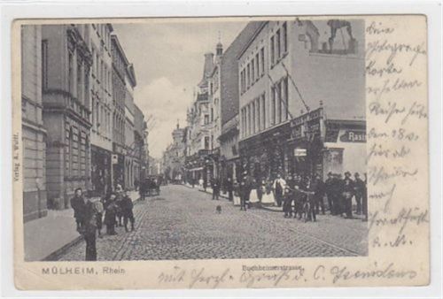Mülheim am Rhein. Buchheimerstrasse mit Personen Friseurgeschäft gelaufen 1904. Kleine Knicke unten links. Vorder- und Rückseite leicht fleckig, sonst gut erhalten
