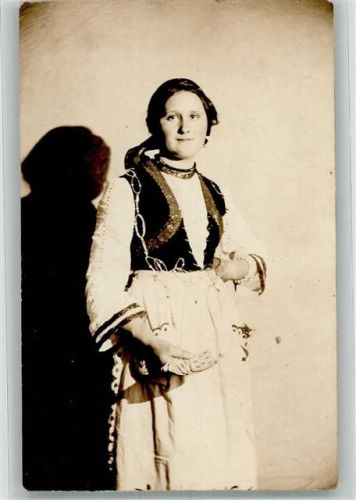 Junge Frau in bunter Tracht mit einem Kartenspiel
