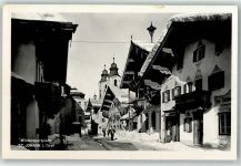 6380 St. Johann in Tirol Foto AK Wintersportplatz Schnee Kirche Straße Tankstelle Gasthaus