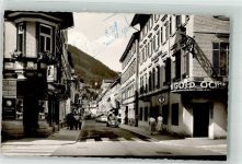 75323 W7547 Bad Wildbad im Schwarzwald Gebrauchsspuren Wilhelmstrasse Geschäft VW Käfer Foto AK