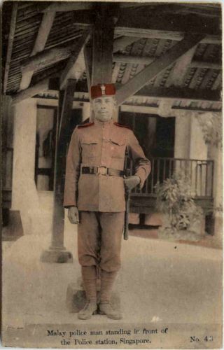 Singapore - Malay police man standing in front of police station
