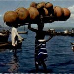 Girl carrying gourds