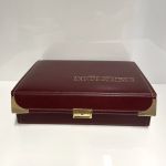 Münzkassette weinrot mit 5 Tableaus und Schlüssel / neuwertig