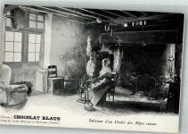 Spinnerin in einem Alpenchalet Klaus Schokolade Werbe AK