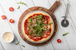 Ham, rocket and tomato pizza