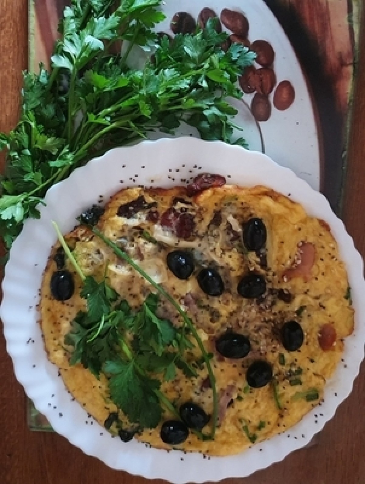 Omelette with bacon, cheese, sunflower seeds and olives