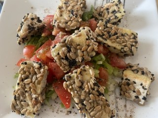 Camembert in Panade aus Samen mit Tomatensalat