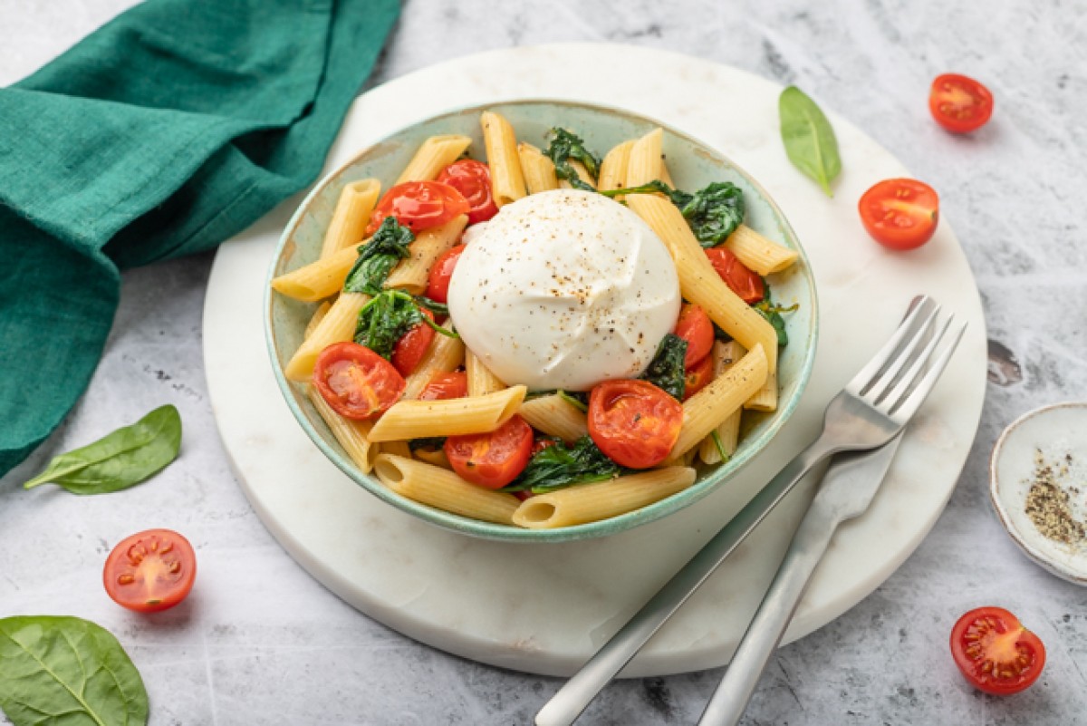 Penne pasta with tomatoes, spinach and burrata