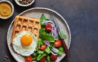 Waffles with fried egg, lettuce and tomato