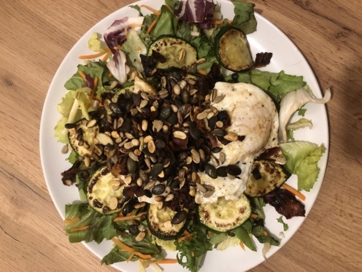 Courgette with bacon, fried egg and pumpkin seeds