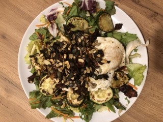 Courgette with bacon, fried egg and pumpkin seeds