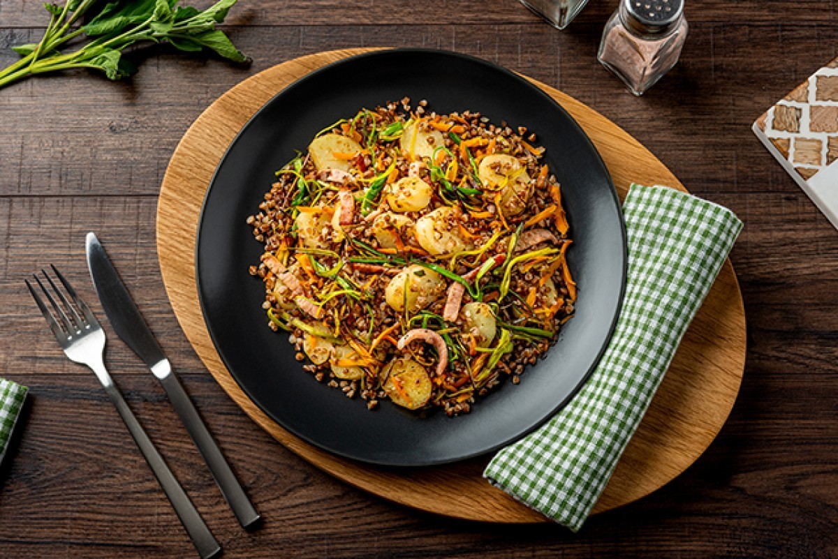 Fried buckwheat groats with ham and potatoes