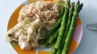 Fish baked in foil with rice and asparagus
