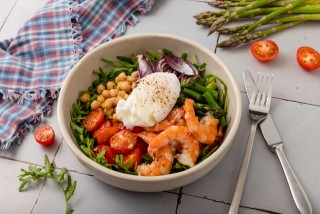 Bowl of shrimps, poached egg, asparagus and cocktail tomatoes