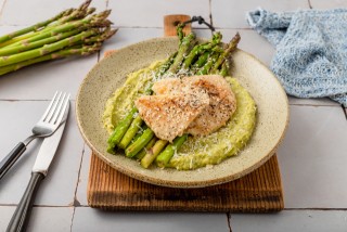 Chicken breasts on green asparagus purée