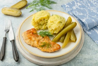 Chuleta de cerdo con puré de patatas y pepino encurtido