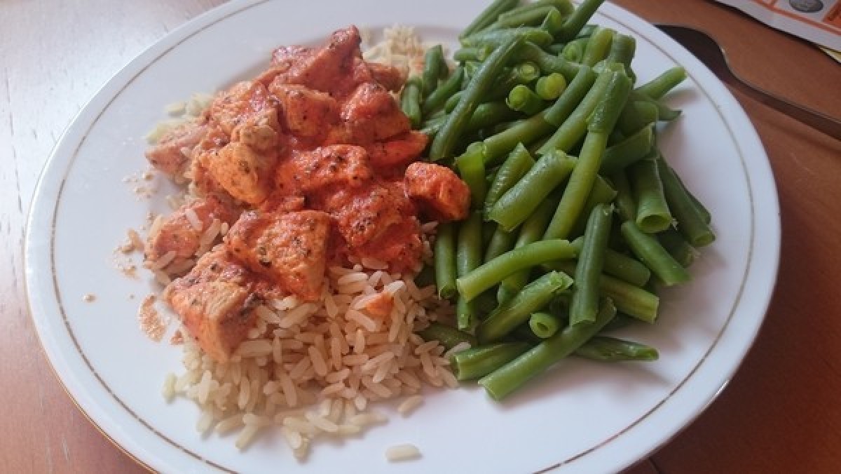 Chicken stewed in wine with rice and beans