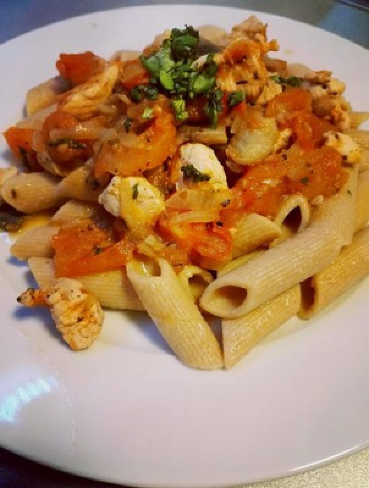 Pasta with chicken and mushrooms in tomato sauce