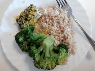 Fish baked with dill and lemon, served with rice and broccoli