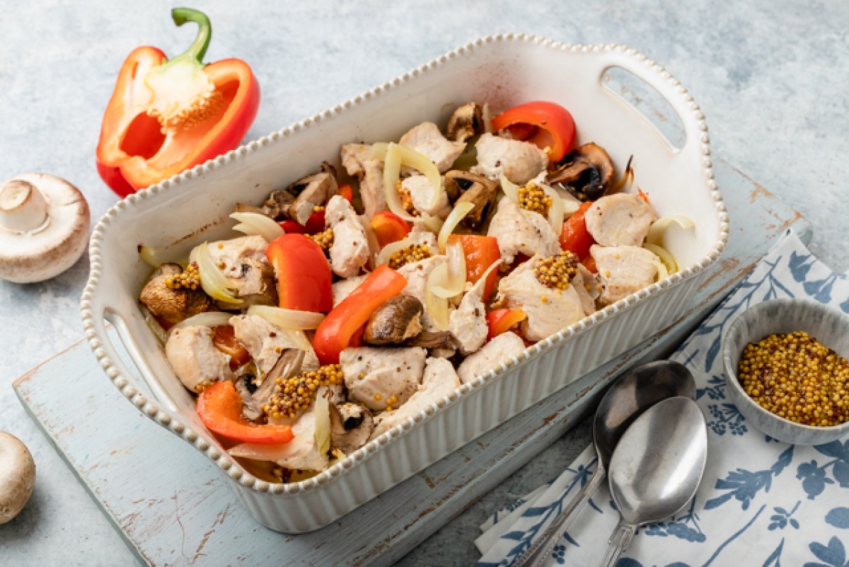 Roast turkey in French mustard marinade with peppers and mushrooms