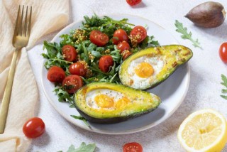 Baked avocado with egg and with salad