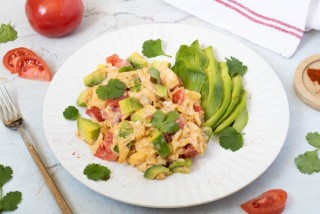 Scrambled eggs with avocado, tomato and coriander